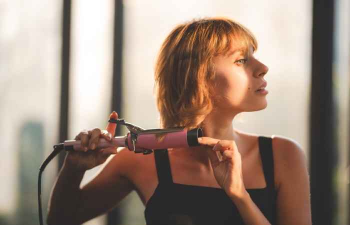 A woman styling her hair