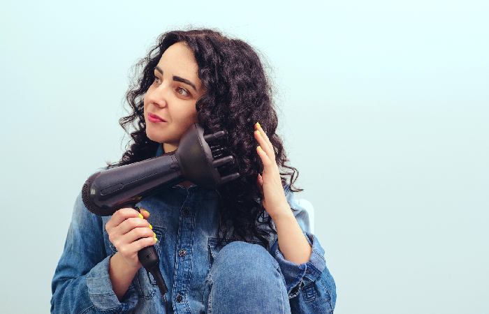 A woman using a hair diffuser