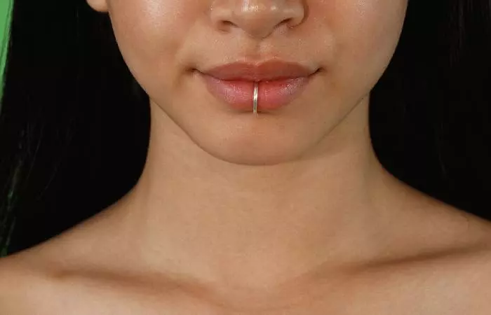 A woman with a lower lip piercing