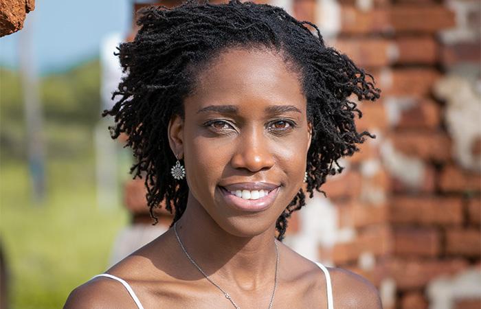 A woman with a short Sisterlocks hairstyle.