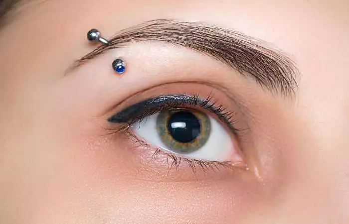 A woman with an eyebrow piercing