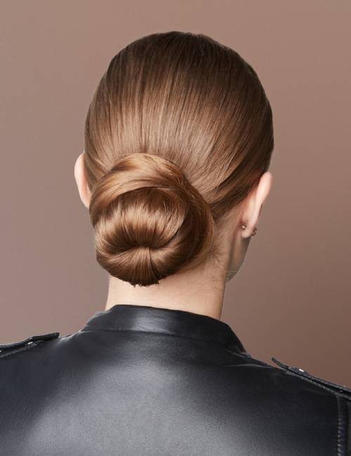 A woman with neatly tied military hair bun