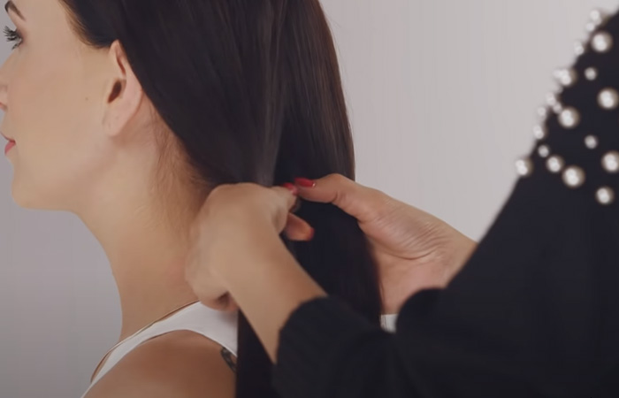 Stylist dividing hair into two sections