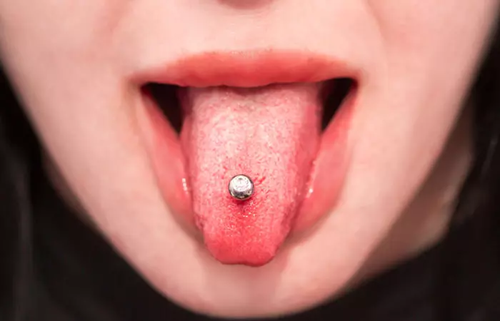 Young woman sporting her tongue piercing