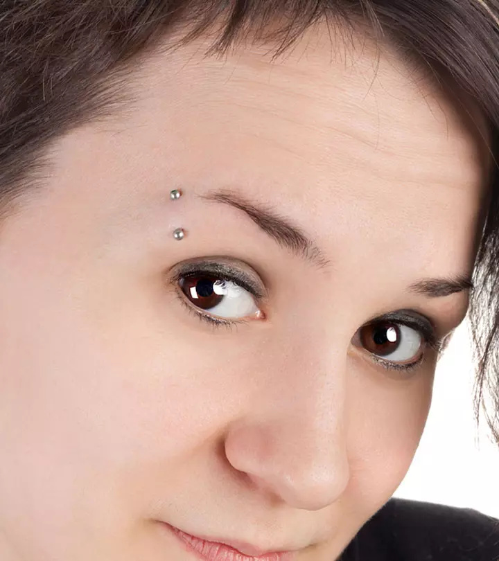 A teenage girl with an eyebrow piercing