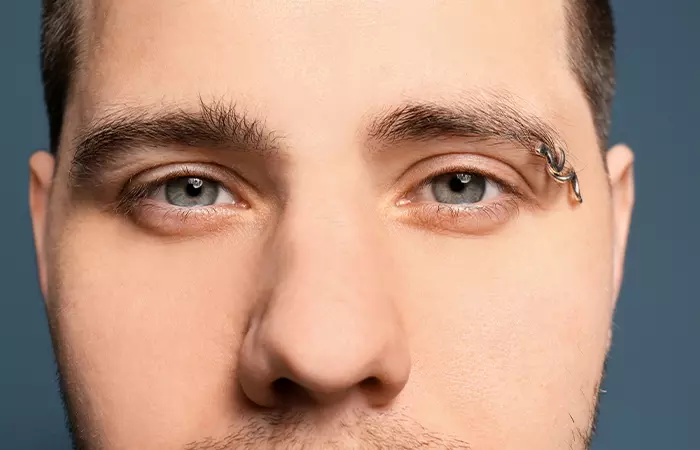 Man with an eyebrow piercing