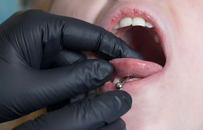 Woman getting her tongue pierced