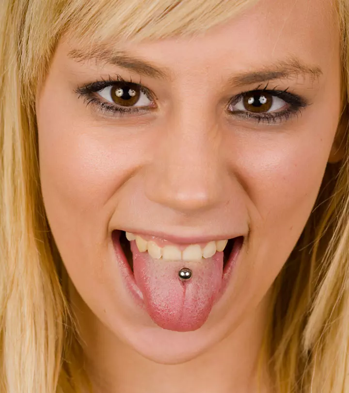 A happy woman with a tongue piercing