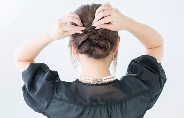 Back view of a girl getting braid done in short hair from a hairdresser