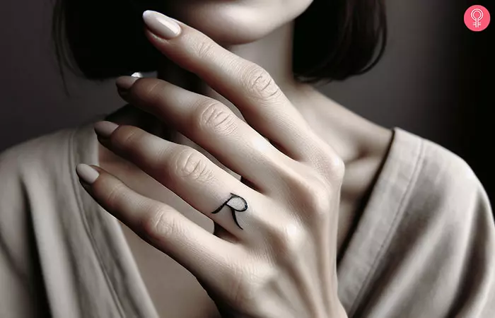 R tattoo on the ring finger