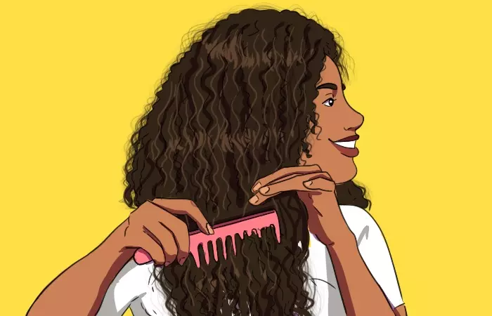 A girl detangling her hair using a wide toothcomb