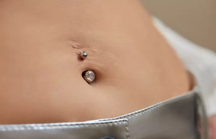 Woman with a scar near her belly button piercing