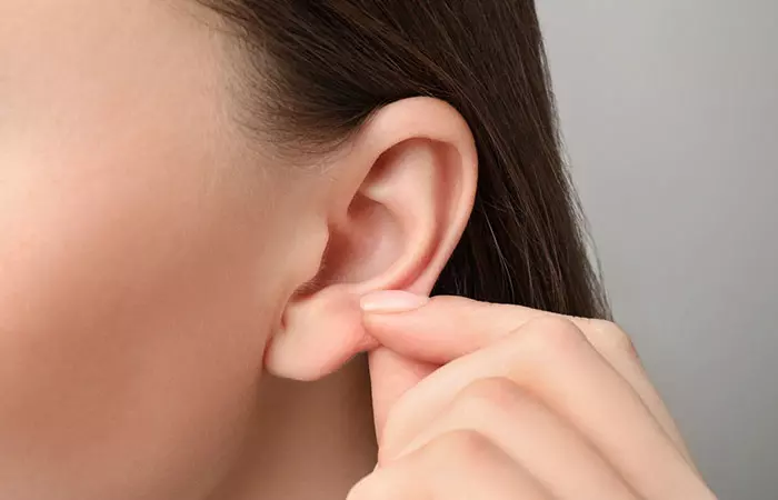 Woman touching her ear piercing