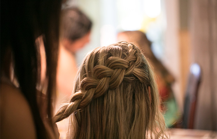 Woman creating a Dutch braid