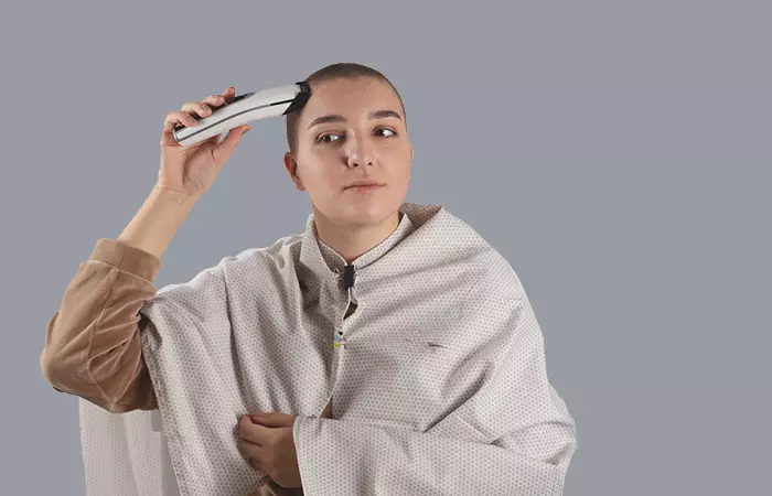 Woman giving herself a buzz cut at home