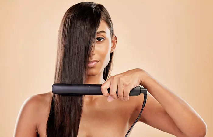 Woman holding an electric straightener