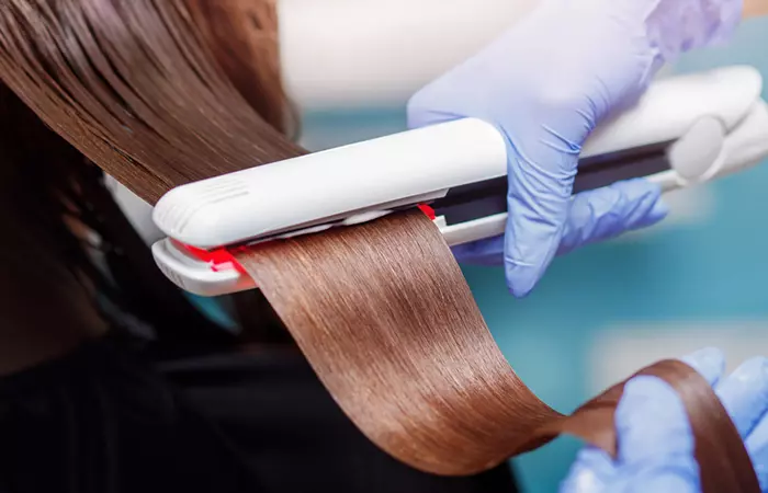 Woman undergoing hair treatment at a salon