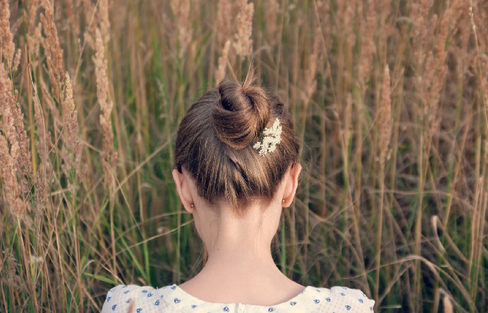 Woman with high ballerina-style bun.