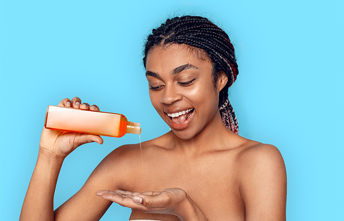 Young woman shampooing box braids hairstyle.