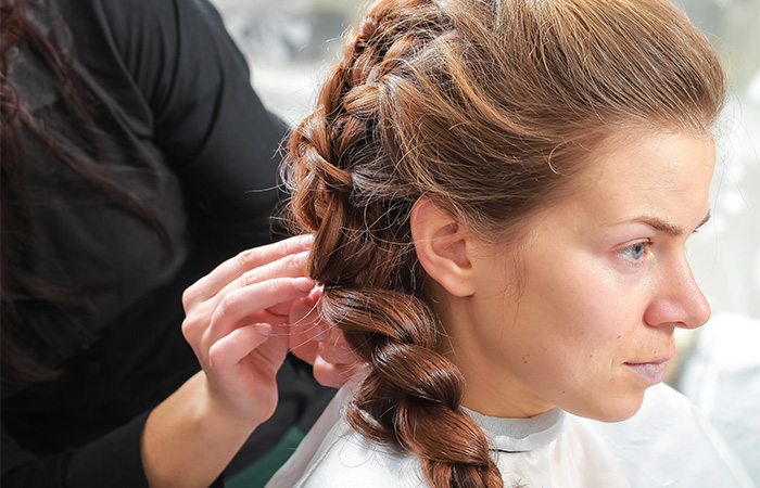 Woman braiding a French braid