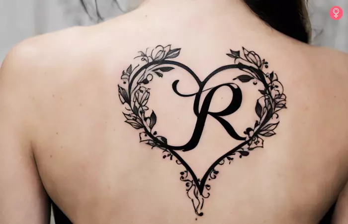 R tattoo with heart on the back