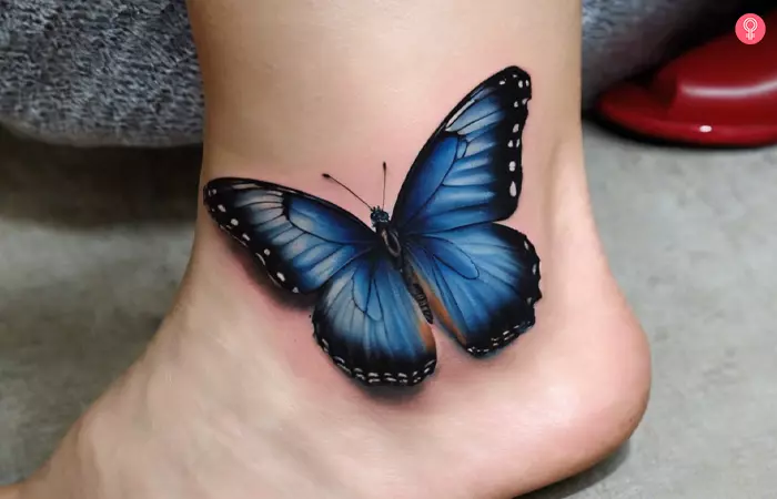 Realistic blue butterfly tattoo on a woman’s ankle