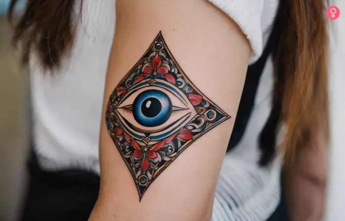 Evil eye protection tattoo on the upper arm