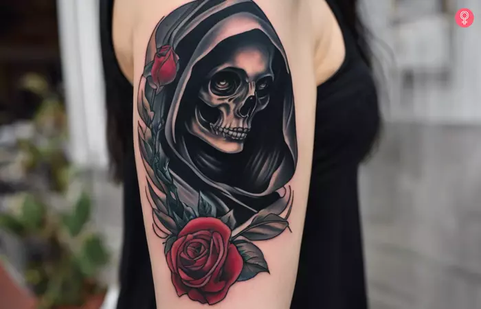 Traditional Grim Reaper tattoo on a woman’s upper arm