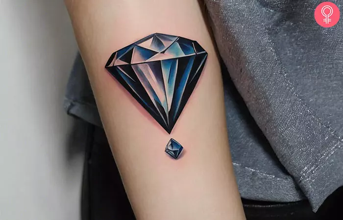 A woman with a 3D diamond tattoo on her forearm