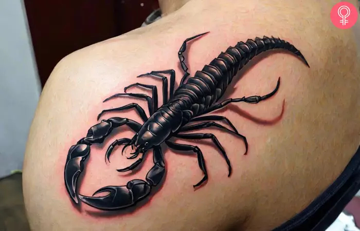 A woman wearing a 3D scorpion tattoo on the upper back