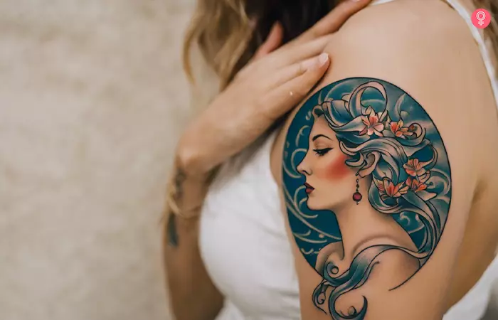 A woman with a female goddess Pisces tattoo on the shoulder