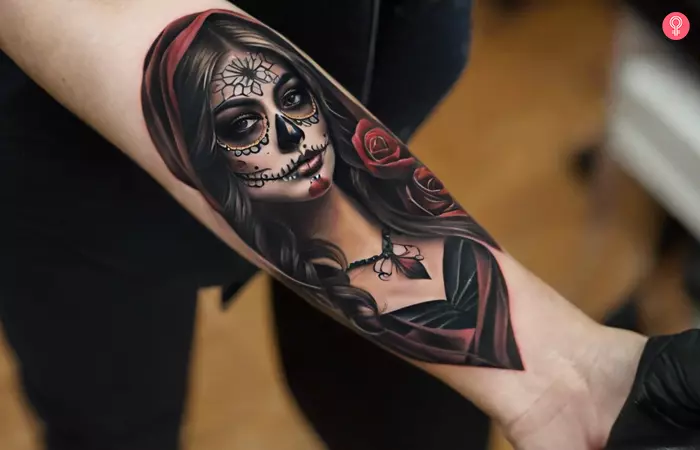 A realistic Day of the Dead tattoo on the back of a woman’s forearm