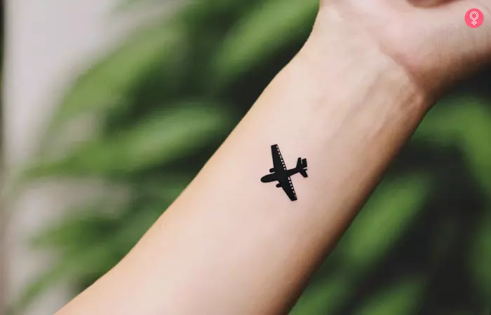 Black airplane tattoo