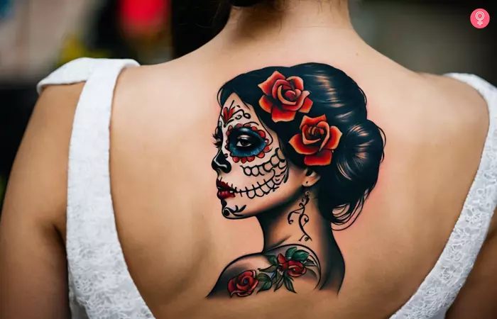 An elegant portrait of La Catrina tattooed on the back of a woman