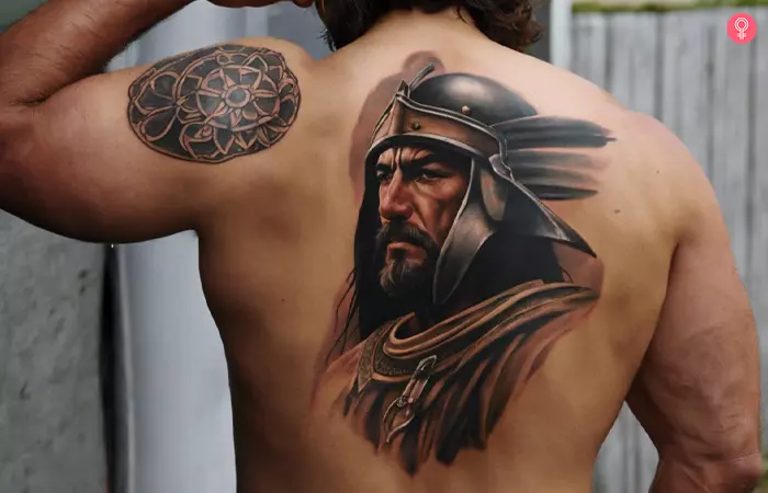 A man with a Spanish warrior tattoo on his back