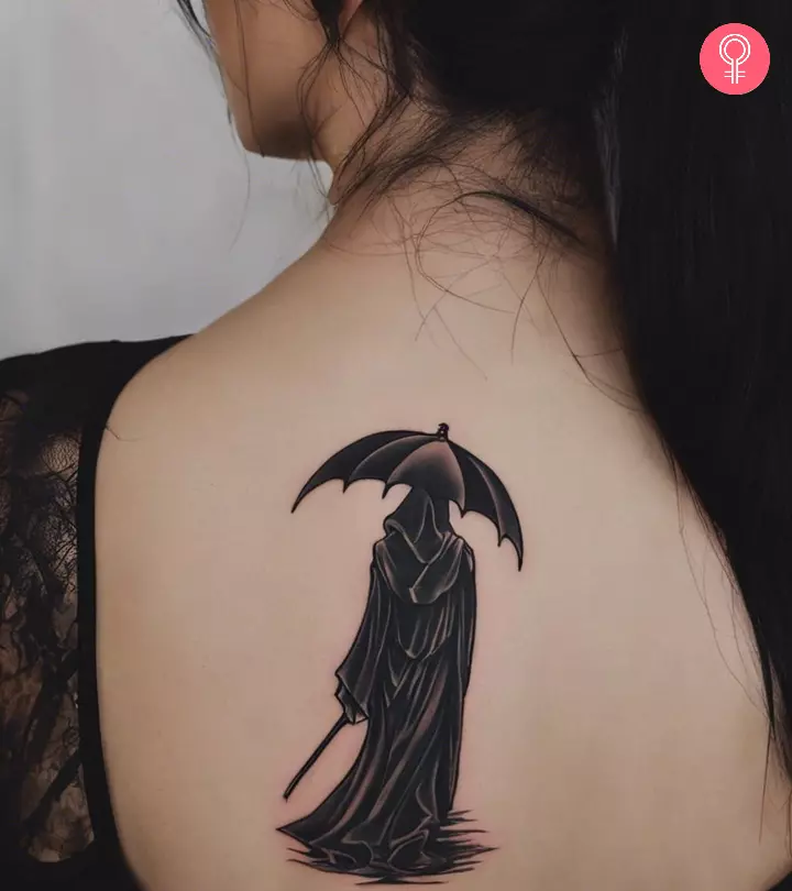 A woman with a Grim Reaper tattoo on her back