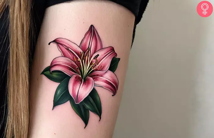 A 3D stargazer lily tattoo on the upper arm