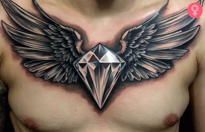 A man with a diamond with wings tattoo on his chest