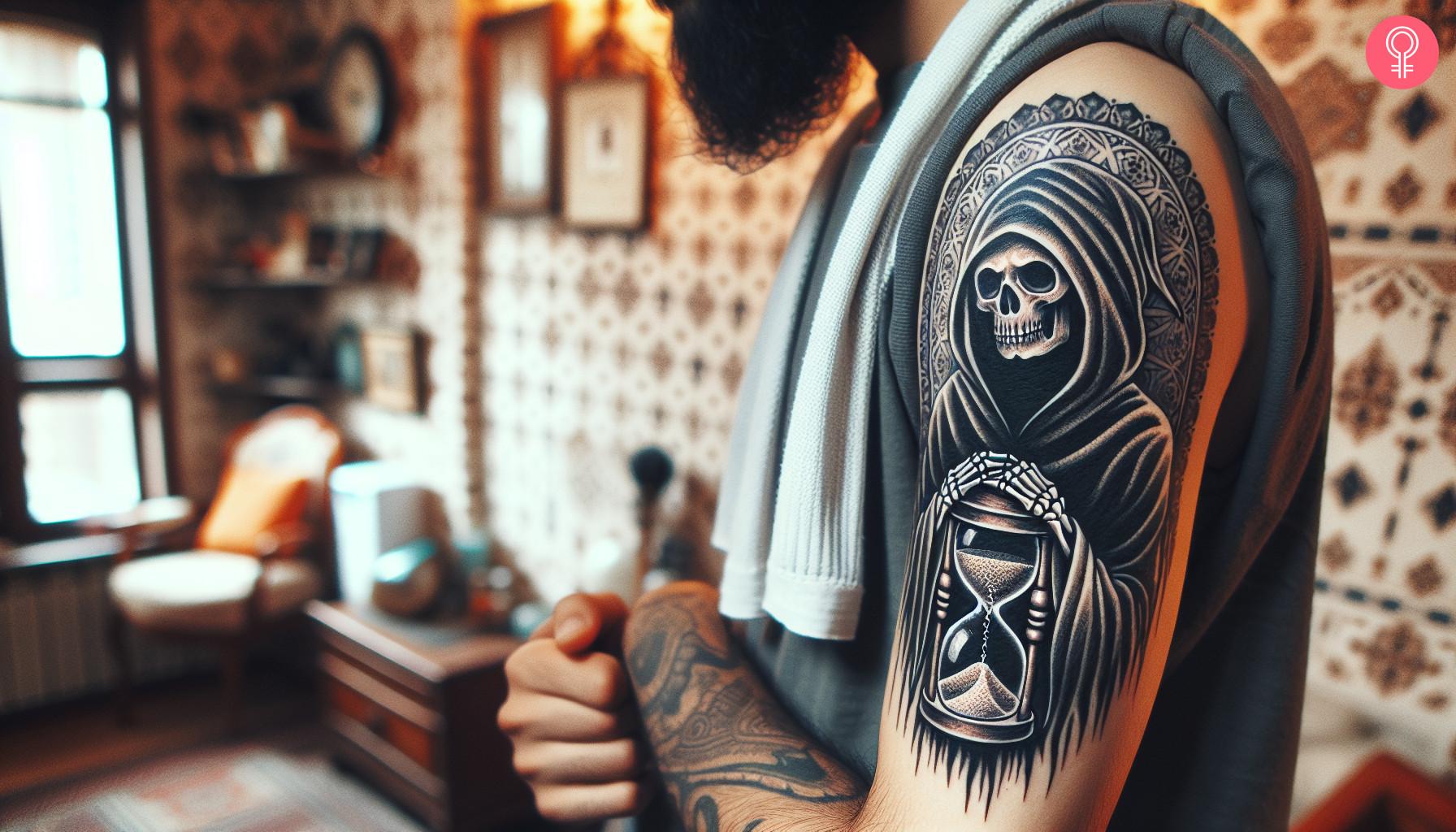 A Grim Reaper hourglass tattoo on the upper arm of a man