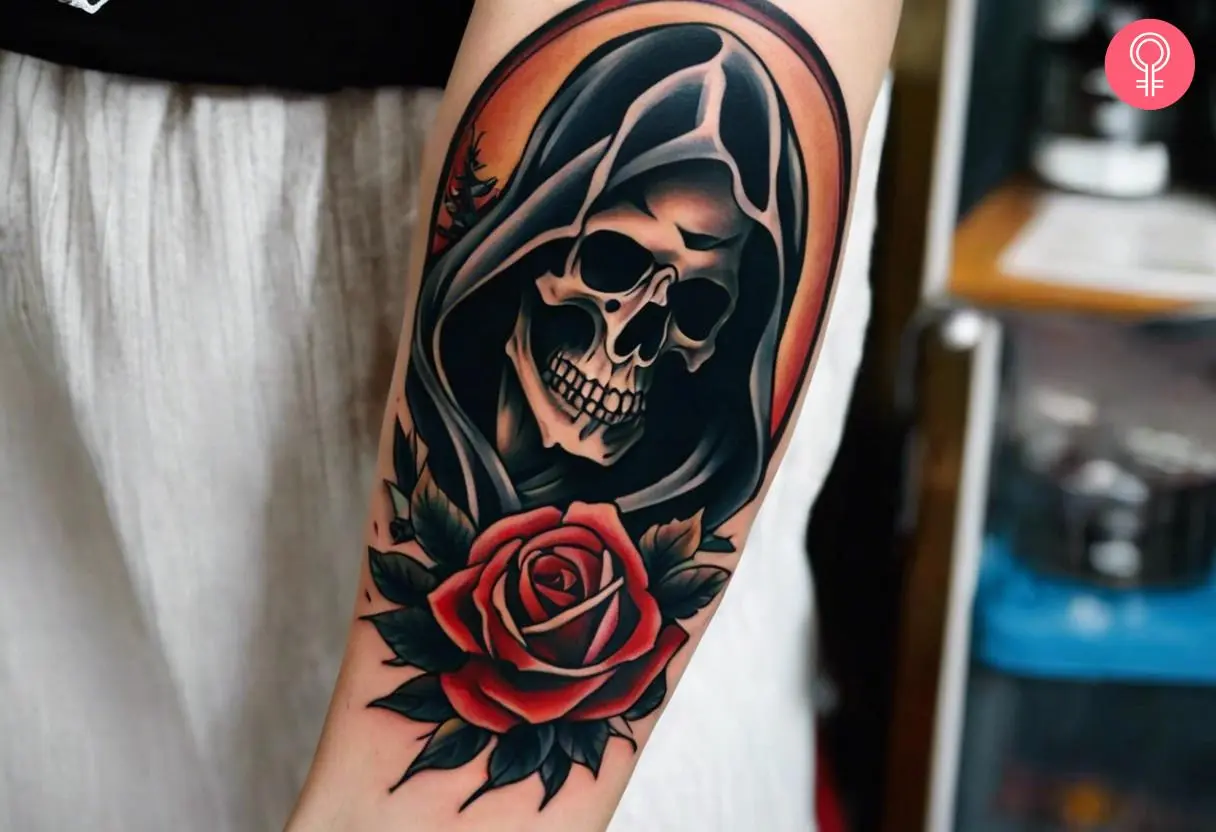 A Grim Reaper skull tattoo on the forearm of a woman