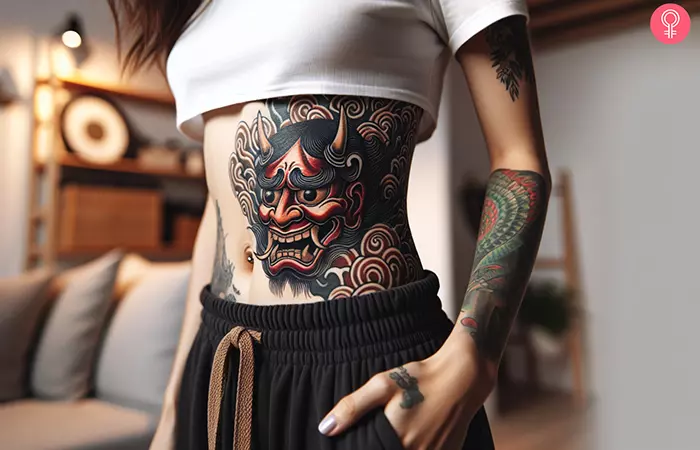 A Hannya mask tattoo on a woman’s stomach