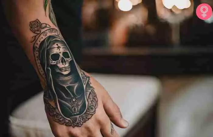 A Santa Muerte tattoo on the hand of a man