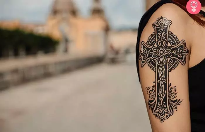 A Spanish cross tattoo on the upper arm