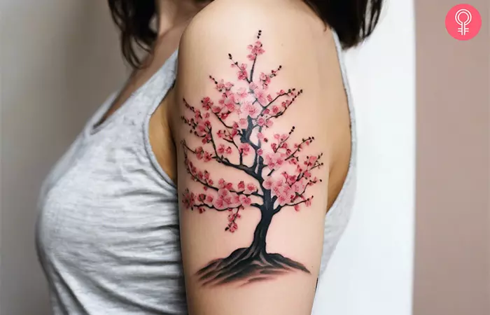 A cherry blossom tree tattoo on the arm