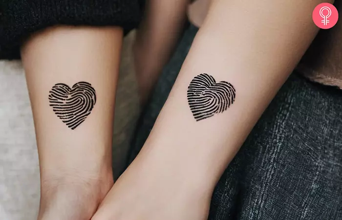 A couple with fingerprint heart tattoos on their forearms
