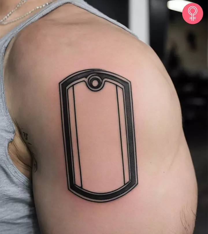 A dog tag tattoo on the upper arm