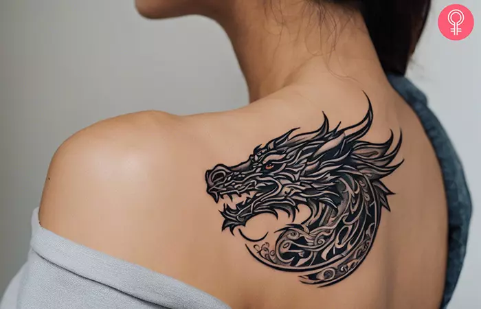 A dragon tattoo on a woman’s shoulder
