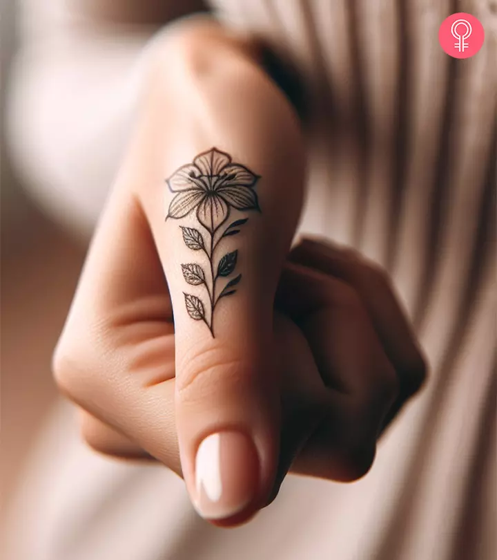 A floral tattoo on a woman’s thumb