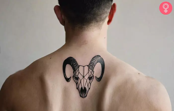 A geometric goat skull tattoo on the back of the neck