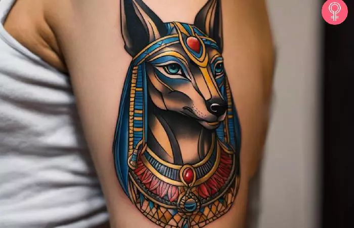 A giant realistic tattoo of Anubis on a woman’s shoulder